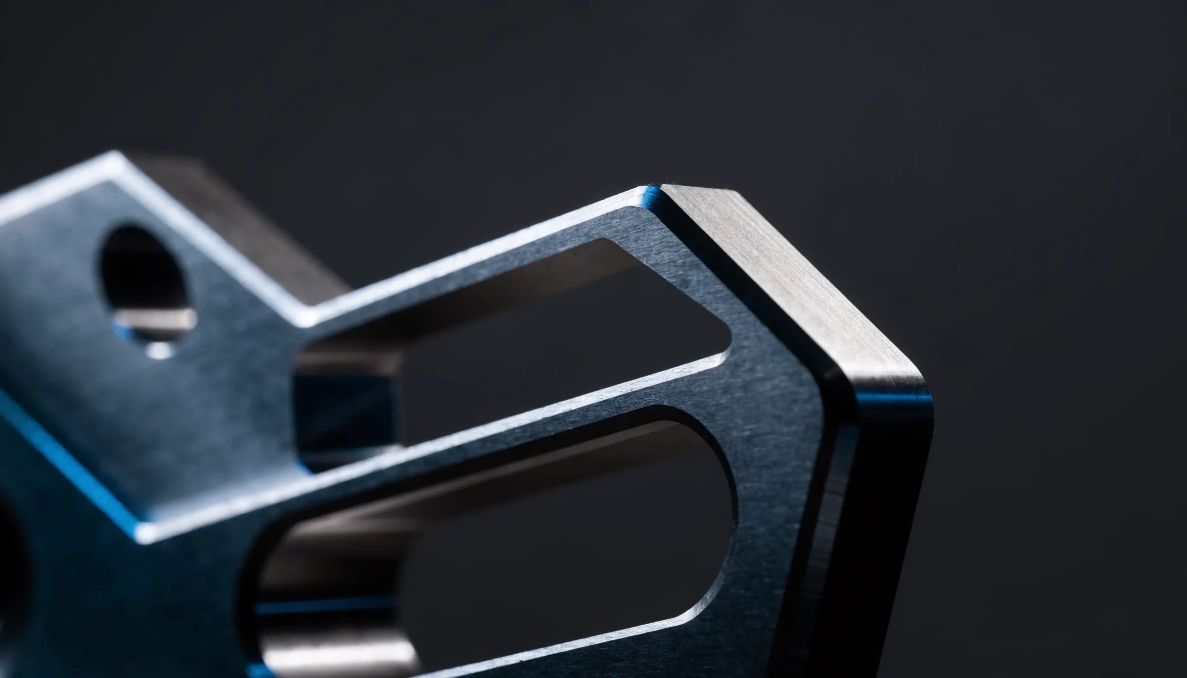 Precision CNC-machined titanium aerospace component under studio lighting